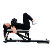 Woman Doing Chest Press with Adjustable Dumbbells Laying on Glute Drive Plus