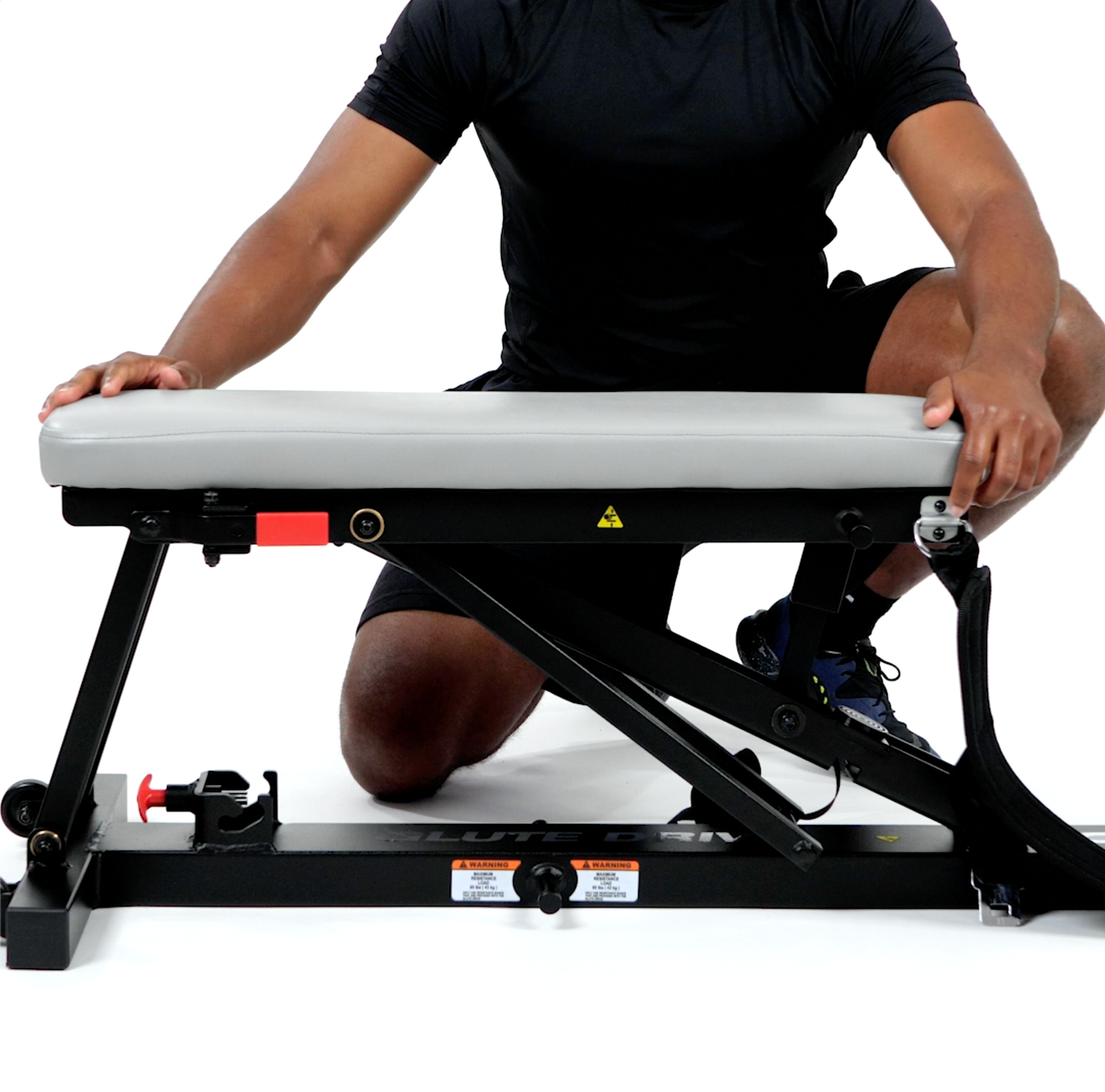 Man Adjusting Glute Drive Plus Machine